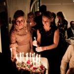 two women holding candles